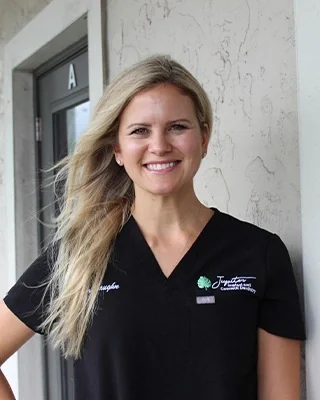 Dr. Amiee Vaughn, DMD, in the office's black scrubs.