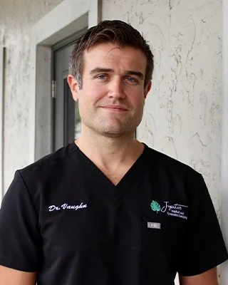 Dr. W. Shane Vaughn, DMD, MS, FAGD, in the office's black scrubs.